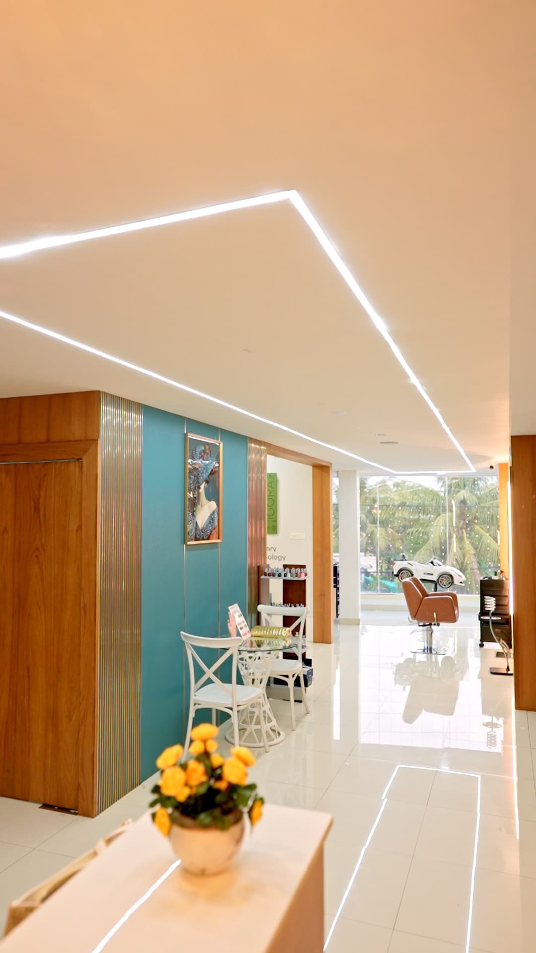 Bright salon interior with a teal accent wall and wooden panelling